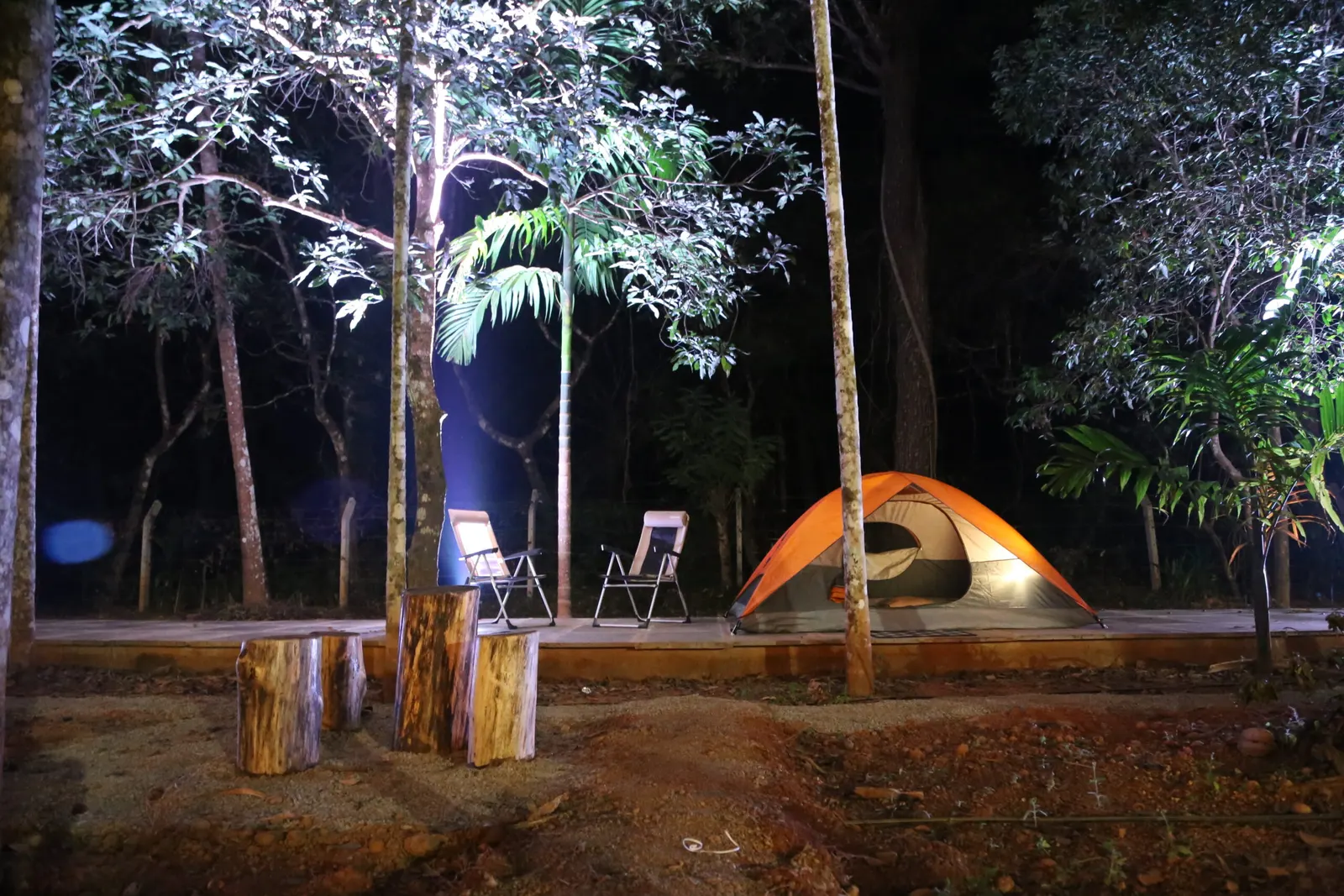 The tent lit on its deck after dark